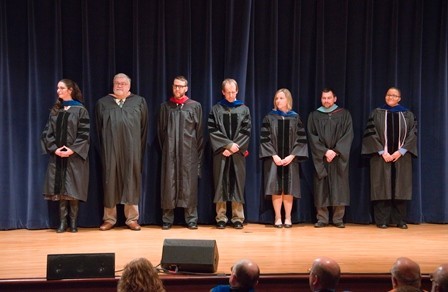 Seven faculty members await their turn to be recognized during ceremony